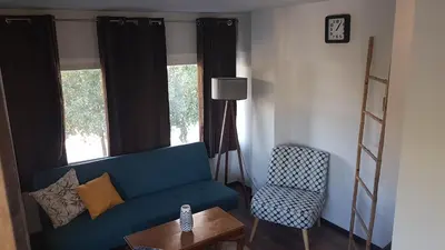 a living room with a blue couch and a chair at Konstantinos Apartments in Athens