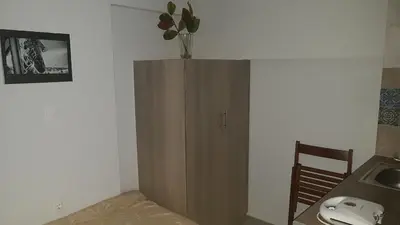 a room with a wooden cabinet with a vase on top at Konstantinos Apartments in Athens
