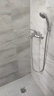 a shower with a shower head in a bathroom at Konstantinos Apartments in Athens