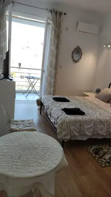 a bedroom with two beds and a large window at Konstantinos Apartments in Athens