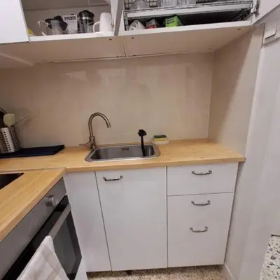 a small kitchen with a sink and white cabinets at Skipper's Urban Endeavor One bed lux central quiet smart cozy apart Athens in Athens