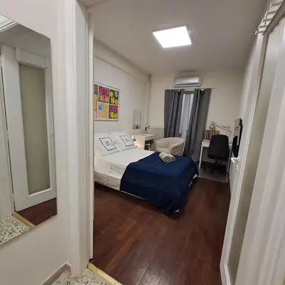 a bedroom with a bed and a desk with a chair at Skipper's Urban Endeavor One bed lux central quiet smart cozy apart Athens in Athens