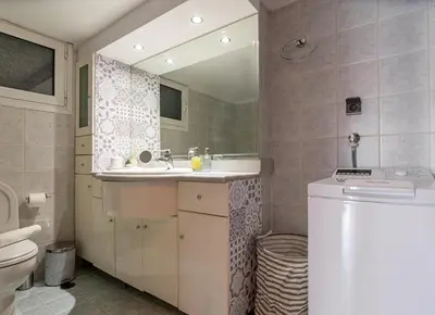a bathroom with a sink and a toilet and a mirror at Near Metro 3 Bedrooms Fiber 100mbps in Athens