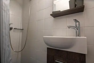 a bathroom with a sink and a shower at Near Metro 3 Bedrooms Fiber 100mbps in Athens