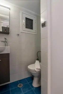 a bathroom with a toilet and a sink at Near Metro 3 Bedrooms Fiber 100mbps in Athens
