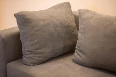 two pillows sitting on top of a couch at Koukaki Comfort - Modern 2BR near Acropolis by ΜΡS in Athens
