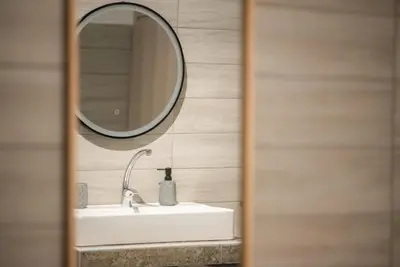 a bathroom with a sink and a mirror at Koukaki Comfort - Modern 2BR near Acropolis by ΜΡS in Athens