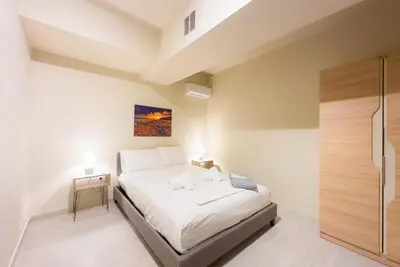a bedroom with a large bed and a shower at Koukaki Comfort - Modern 2BR near Acropolis by ΜΡS in Athens