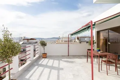 a balcony with a table and a view at Serenity Penthouse with terrace in Exarcheia in Athens