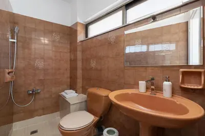 a bathroom with a toilet and a sink and a shower at Serenity Penthouse with terrace in Exarcheia in Athens