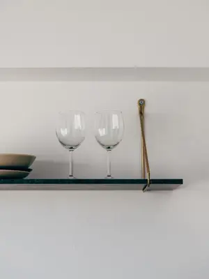three wine glasses on a shelf with a wand at Serenity Penthouse with terrace in Exarcheia in Athens