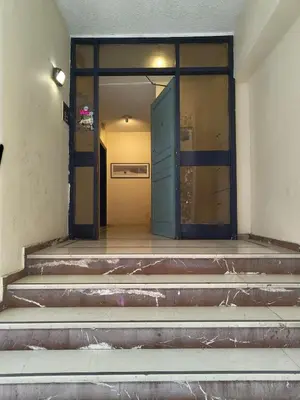 an entrance to a building with a blue door at Serenity Penthouse with terrace in Exarcheia in Athens