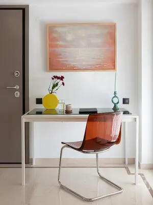 a desk with a chair and a yellow vase on it at Serenity Penthouse with terrace in Exarcheia in Athens
