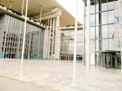 a large building with white columns and windows at GreenGarden Comfort in Athens