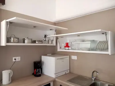 a kitchen with a white refrigerator and a sink at GreenGarden Comfort in Athens