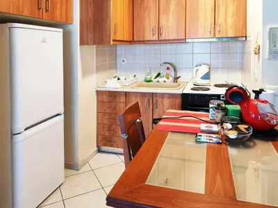 a kitchen with a table and a white refrigerator at Oulang Easy Stay apartment - Athens Center in Athens