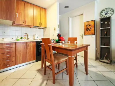 a kitchen with a wooden table and chairs at Oulang Easy Stay apartment - Athens Center in Athens
