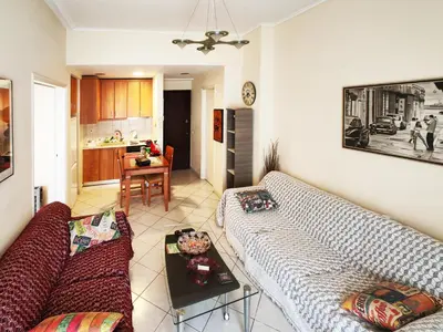 a living room with a couch and a table at Oulang Easy Stay apartment - Athens Center in Athens
