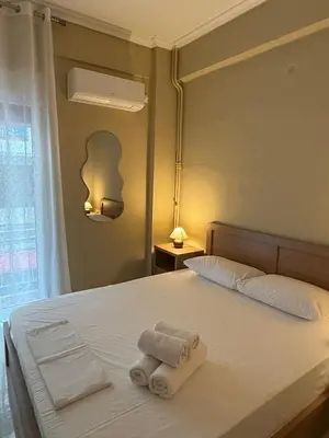 a bedroom with a bed with two towels on it at Gaia Athens Apartment in Athens