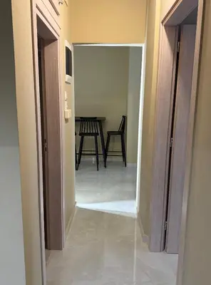 a hallway leading to a dining room with a table at Gaia Athens Apartment in Athens