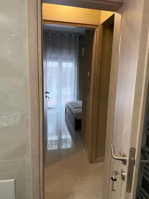 a door to a room with a bed and a bedroom at Gaia Athens Apartment in Athens