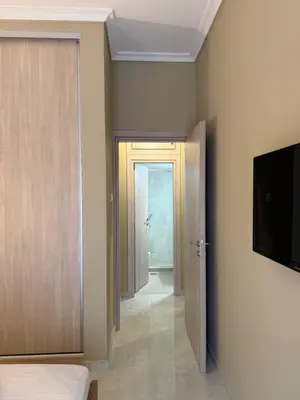 a room with a hallway with a door and a television at Gaia Athens Apartment in Athens