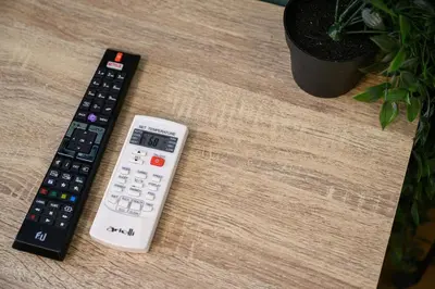 two remote controls sitting on top of a table at Amorgou maisonette in Athens