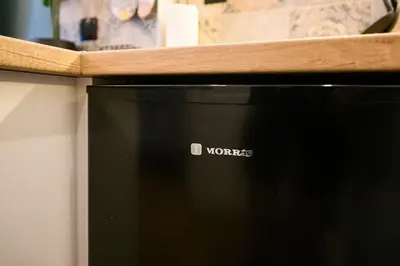 a black microwave sitting on top of a counter at Amorgou maisonette in Athens