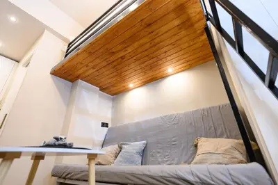 a loft bed in a room with a staircase at Amorgou maisonette in Athens