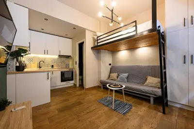 a living room with a loft bed and a kitchen at Amorgou maisonette in Athens