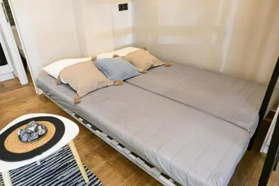 a bed in a room with a hat on a table at Amorgou maisonette in Athens
