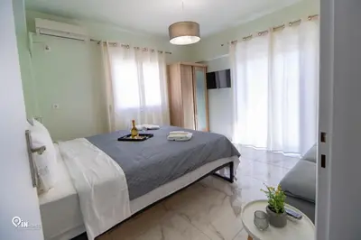 a bedroom with a bed with a bottle of wine on it at Ariadne - Elegant & Chic House in Egaleo-Athens in Athens