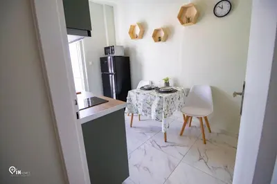 a small kitchen with a table and a refrigerator at Ariadne - Elegant & Chic House in Egaleo-Athens in Athens