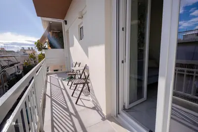 a balcony with chairs and tables on a building at Ariadne - Elegant & Chic House in Egaleo-Athens in Athens