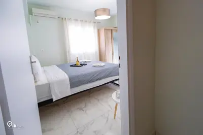 a bedroom with a bed with a bottle of wine on it at Ariadne - Elegant & Chic House in Egaleo-Athens in Athens