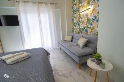 a living room with a bed and a couch at Ariadne - Elegant & Chic House in Egaleo-Athens in Athens