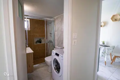 a bathroom with a washing machine and a toilet at Ariadne - Elegant & Chic House in Egaleo-Athens in Athens