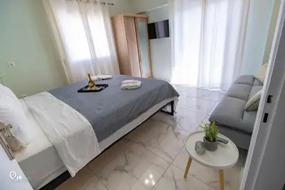 a small bedroom with a bed and a couch at Ariadne - Elegant & Chic House in Egaleo-Athens in Athens
