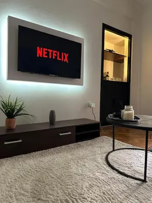 a living room with a netflix sign on the wall at Dear Athens Suite in Athens