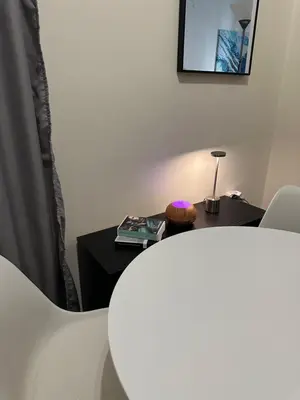 a room with a table with a lamp and a table with a chair at Dear Athens Suite in Athens