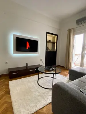 a living room with a couch and a table at Dear Athens Suite in Athens
