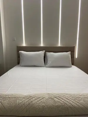 a large bed with two white pillows in a room at Dear Athens Suite in Athens