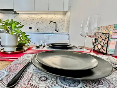 a table with a black plate on top of a table at Urban Calm Glyfada Getaway 2BD in Athens
