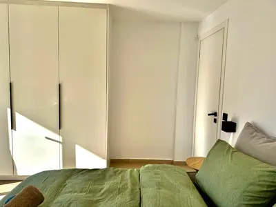 a bedroom with a bed and a large window at Urban Calm Glyfada Getaway 2BD in Athens