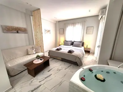 a room with a bed and a bath tub at Lux Suite Jacuzzi Acropolis byMK in Athens