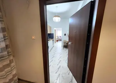 a hallway with a wooden door and a hallway with a room at Lux Suite Jacuzzi Acropolis byMK in Athens