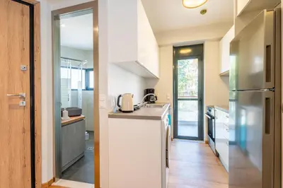 a kitchen with a refrigerator and a counter top at AURA Gazi apartments in Athens