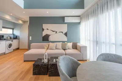 a living room with a couch and chairs and a table at AURA Gazi apartments in Athens