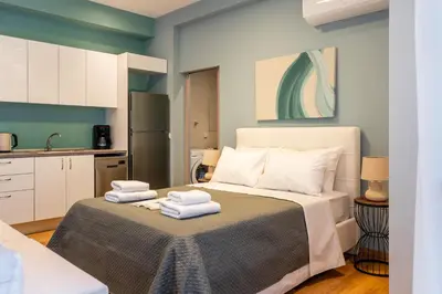 a bedroom with a bed with towels on it at AURA Gazi apartments in Athens