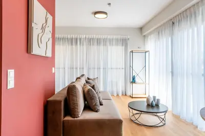 a living room with a couch and a table at AURA Gazi apartments in Athens